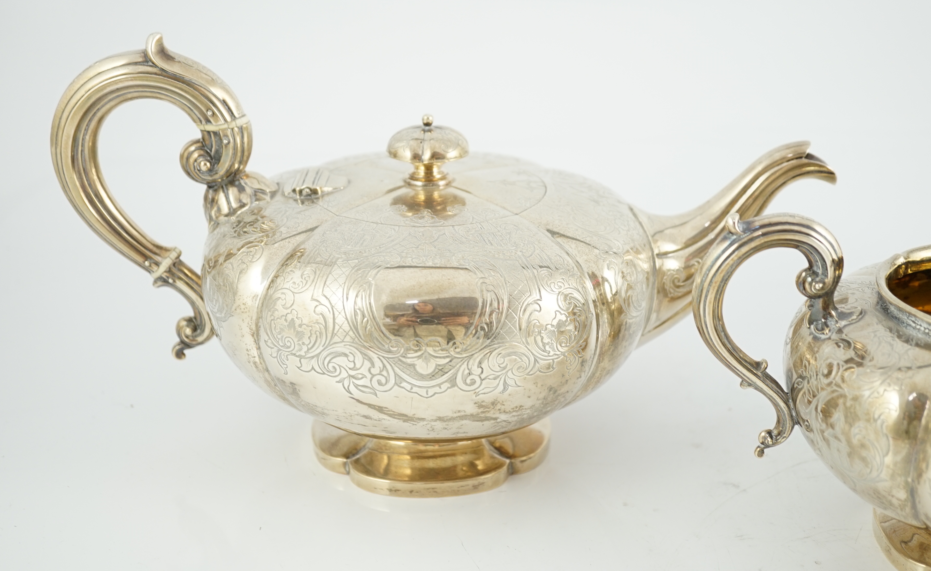 A Victorian silver three piece melon shaped tea set, by Charles Reily & George Storer